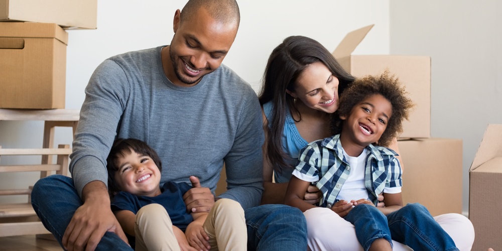 Picture of a happy family surrounded by boxes