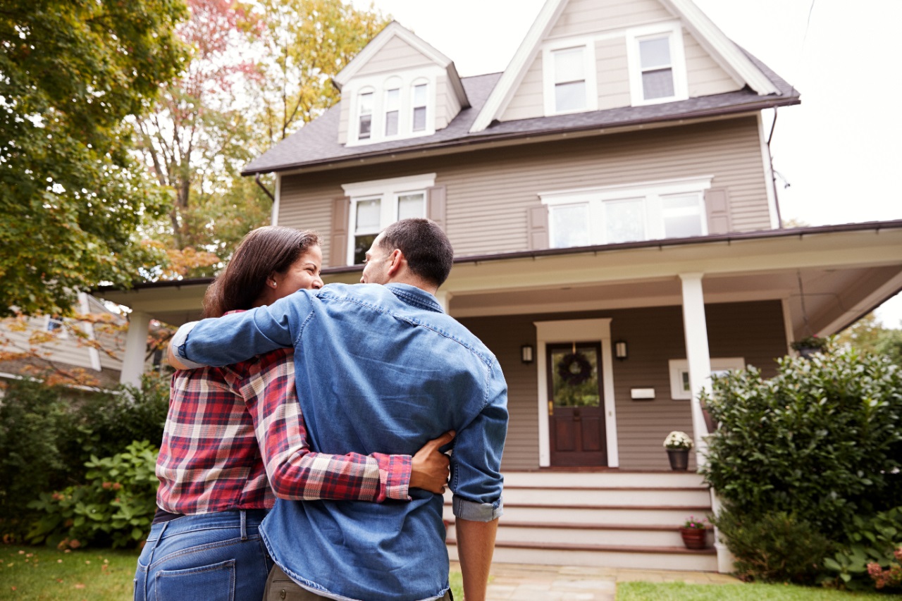 Happy couple looking at a house