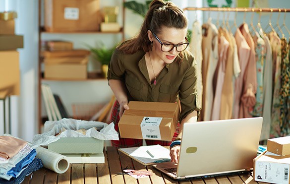 stylish small business owner woman using laptop in office